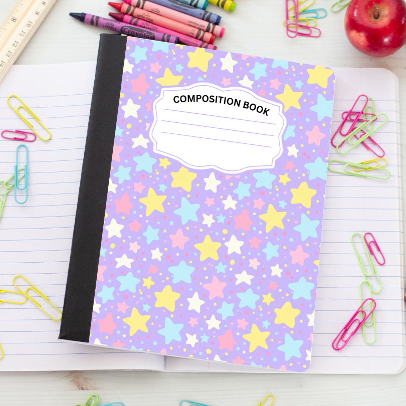 A composition book with a pastel purple cover decorated with yellow, pink, and blue stars, displayed on an open lined notebook surrounded by school supplies like paper clips, crayons, and an apple.