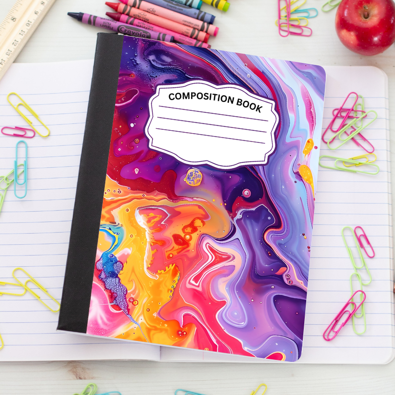 A colorful composition notebook with a black spine and a swirling marbled cover in purple, pink, orange, and blue, placed on an open lined notebook surrounded by paper clips, crayons, a ruler, and an apple.