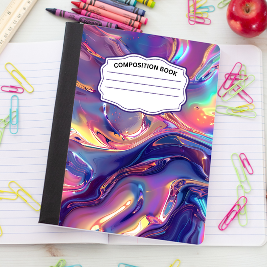 A composition notebook with a glossy, iridescent marbled cover in shades of purple, blue, pink, and gold, placed on an open lined notebook surrounded by school supplies like paper clips, crayons, and an apple.