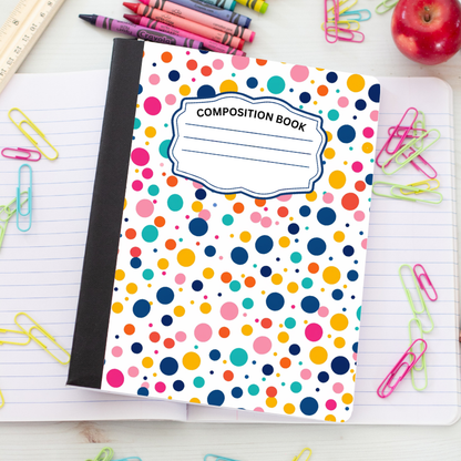 A composition book with a white cover covered in colorful polka dots, featuring a black spine and a white label that reads 'COMPOSITION BOOK'. It is styled on a lined notebook surrounded by school supplies like colored paperclips, crayons, and an apple.