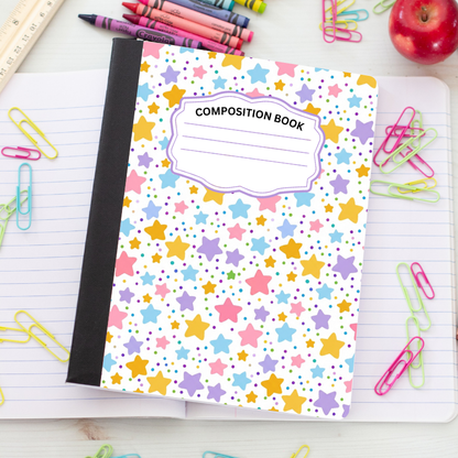 A composition book with a white cover decorated with colorful stars and dots, placed on an open lined notebook surrounded by school supplies like paper clips, crayons, and an apple.